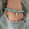N4588 Bracelet Howlite Turquoise breloques plume argentée - Bijoux Bracelets en ligne Ninanina