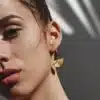 Zoom sur Créoles demi-lune en plaqué or 14 carats gold filled portées par une jeune fille les cheveux relevés, bijou fait main signé Ninanina